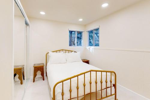 a bedroom with a bed in a white room at Running Springs Sanctuary in Running Springs