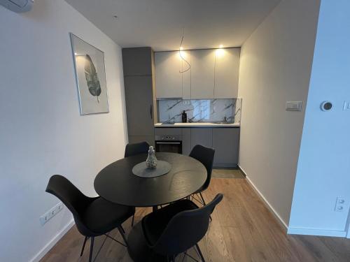 a kitchen with a table and chairs in a room at Residence 33 in Sarajevo