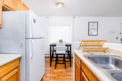 a kitchen with a sink and a white refrigerator at Midtown Classic in Anchorage