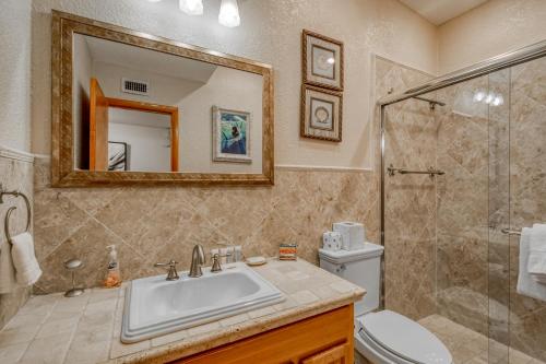 a bathroom with a sink and a shower and a toilet at Escape to the Keys in Islamorada