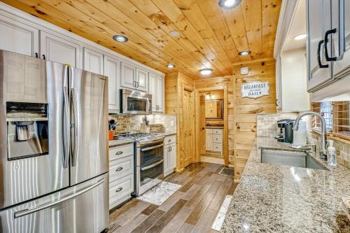 a kitchen with white cabinets and a wooden ceiling at Siesta Chalet in Blue Ridge