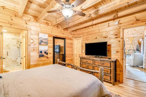 a bedroom with a bed and a flat screen tv at Siesta Chalet in Blue Ridge