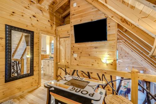 a log cabin living room with a flat screen tv at Siesta Chalet in Blue Ridge