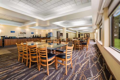 a large dining room with tables and chairs at Best Western Grand Victorian Inn in Sayre