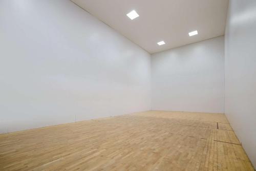 an empty room with white walls and a wooden floor at Best Western Grand Victorian Inn in Sayre