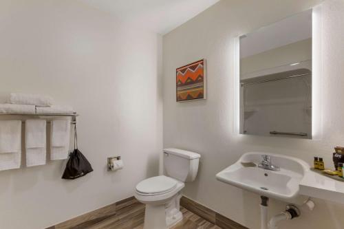 a white bathroom with a toilet and a sink at Best Western Plus Yuma Foothills Inn & Suites in Yuma