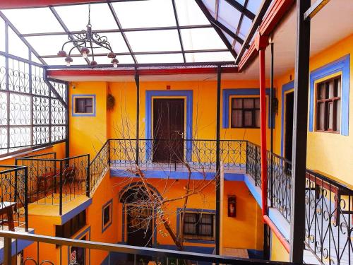 a colorful building with a balcony and a door at Hostal Compañía de Jesús in Potosí