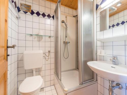 a bathroom with a shower and a toilet and a sink at Illusion in Flachau
