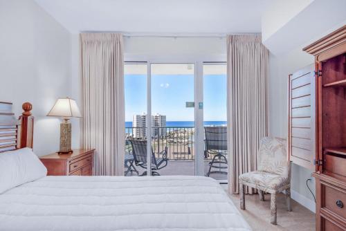 a bedroom with a bed and a view of the ocean at Ariel Dunes II 1003 in Destin