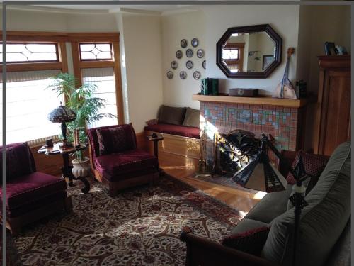 a living room with a fireplace and a mirror at Beautiful Edwardian Victorian Homestay B&B in San Francisco