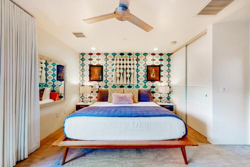 a bedroom with a bed and a ceiling fan at Cerritos Style Permit #48864 in Palm Springs