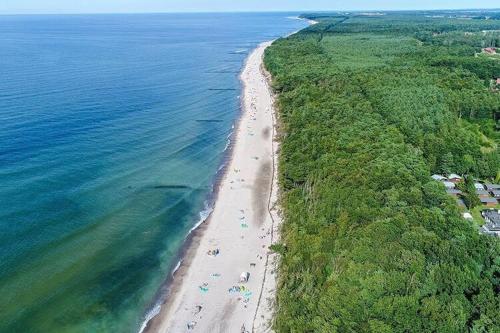 an aerial view of a beach with people on it at 2 room holiday apartment for 3 people Rusinowo in Rusinowo