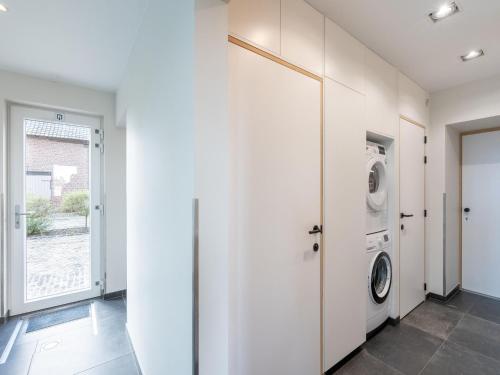a laundry room with a washer and dryer at Holiday Home with pond in Poperinge in Beveren