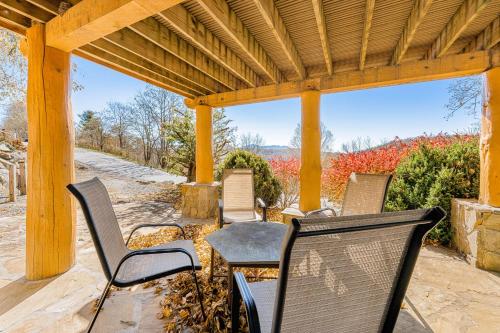 a group of chairs sitting under a wooden pergola at The Potato House in Banner Elk