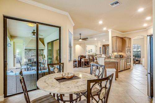 a dining room and kitchen with a table and chairs at Lisburn Lake View in Bonita Springs