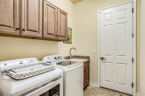 a kitchen with a washing machine and a sink at Lisburn Lake View in Bonita Springs