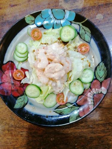 a plate of food with shrimp and cucumbers on a table at Cullintra House in New Ross