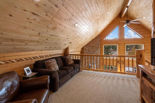 a living room with a couch and a wooden ceiling at Mule Deer Cabin in West Yellowstone