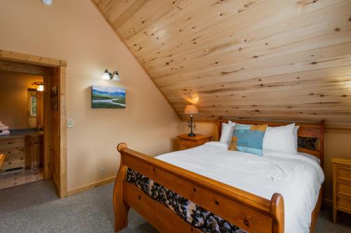 a bedroom with a bed and a wooden ceiling at Mule Deer Cabin in West Yellowstone