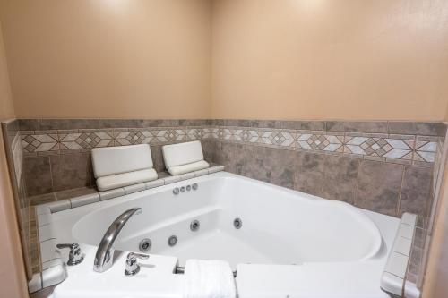a bathroom with a tub and a sink at Mule Deer Cabin in West Yellowstone