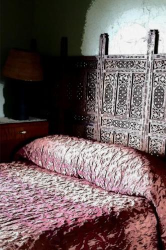 a bedroom with a bed with a red comforter at Forest Edge in Barrytown