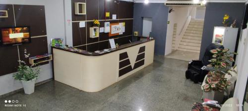 a lobby with a counter in a room at Hotel Foz Brasil in Foz do Iguaçu