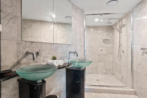a bathroom with a glass sink and a shower at Sirocco 906 in Mooloolaba