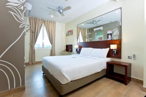 Ένα ή περισσότερα κρεβάτια σε δωμάτιο στο Tune Hotel Georgetown Penang