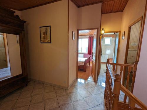 a hallway of a house with a staircase and a bedroom at Gîte familial à Barret : Jardin clos, équipement bébé, proche circuits de rando et Jonzac - FR-1-653-155 in Barret