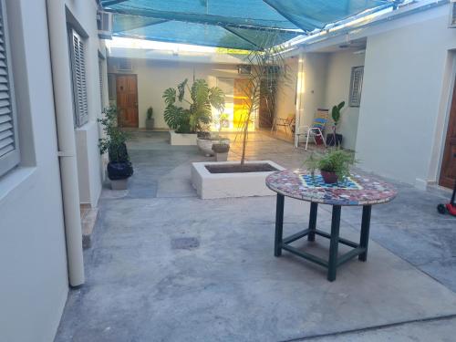 a patio with a table with potted plants on it at Hotel Anmara in San Juan