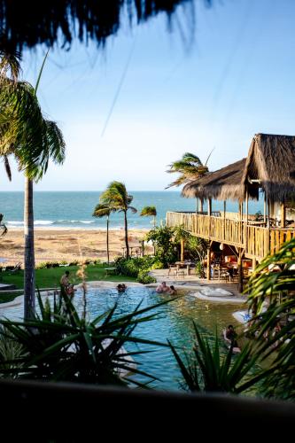 a resort with a swimming pool and a beach at Hurricane Jeri in Jericoacoara
