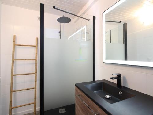 a bathroom with a black sink and a mirror at Maison Confortable à La Bourboule, 130m², Jardin, Proche Centre et Thermes - FR-1-608-237 in La Bourboule