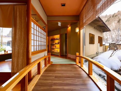 a hallway of a house with a wooden staircase at Keiryuso Siorie in Matsumoto