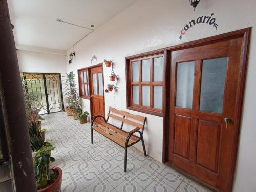 a bench sitting in a room with a door at Casa petirrojo - habitaciones en Pátzcuaro in Pátzcuaro