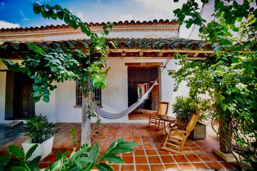a patio of a house with a hammock in it at Casa Portal de la Bodega in Mompos