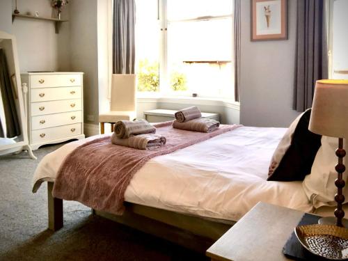 a bedroom with a large bed with two pillows on it at Number Five in Filey