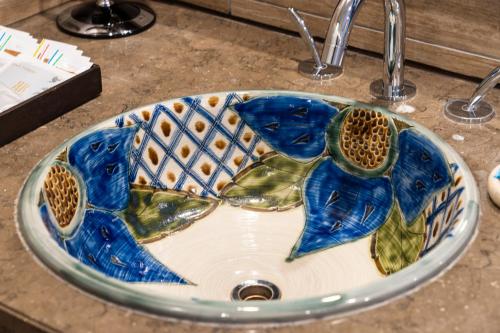 a bathroom sink with a blue fish painted on it at Rihga Royal Gran Okinawa in Naha