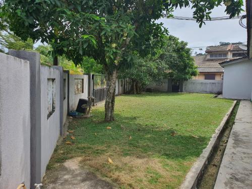 a yard with a tree and a fence at D'Salbiah Homestay in Kemaman
