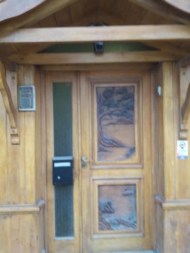 a wooden door with a painting on it at Departamentos Paisaje del Beagle in Ushuaia