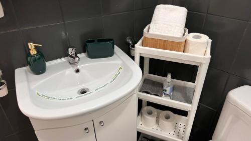 a bathroom with a sink and a toilet and towels at Downtown Studio in Bucharest
