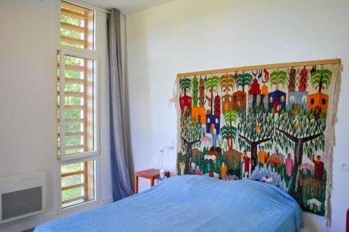 une chambre avec un lit avec un tableau sur le mur dans l'établissement Ancienne séchoir à Tabac idéalement placé à Limeuil pour 4 dans la nature, à Limeuil