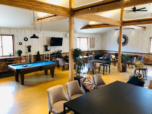 a room with a ping pong table and chairs at Hotel Japan Shiga in Yamanouchi