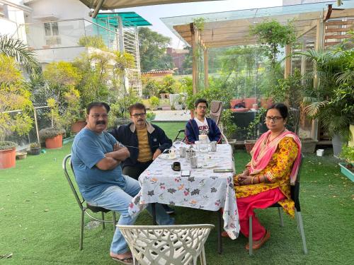 a group of people sitting at a table at GREEN HOME STAY in Lucknow