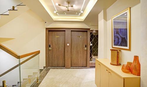 a hallway with a wooden door with a ceiling at Treebo Premium Golden Bliss Trimurti Nagar Square in Nagpur