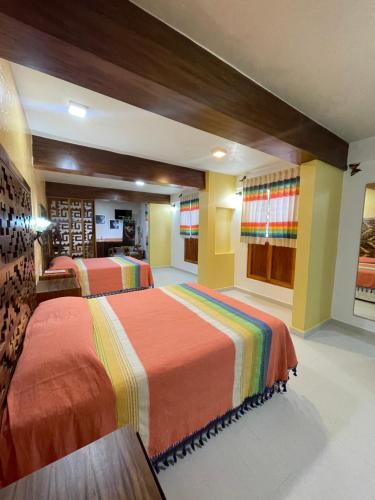 a bedroom with two beds in a room at Suites Cárdon in Oaxaca City