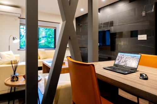 a laptop sitting on a table in a room at Suite Villa Nasu Forest House in Nasu