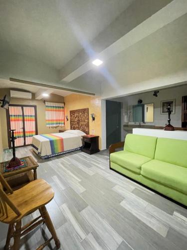 a large living room with a bed and a couch at Suites Cárdon in Oaxaca City