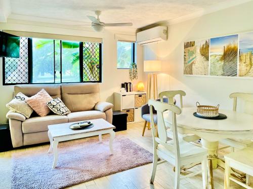 a living room with a couch and a table at Mermaid Beach Park View in Gold Coast