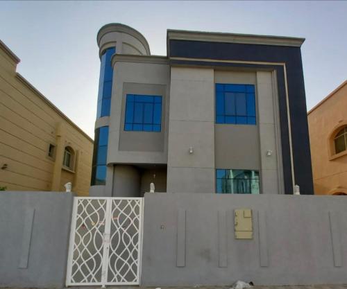 a building with a fence in front of it at فيلا خاصة في عجمان مكونة من طابقين in Al Ḩamīdīyah