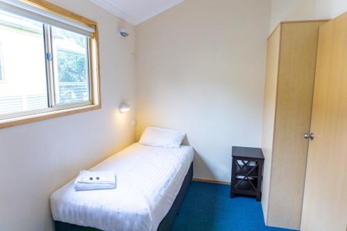 a small room with two beds and a window at Thou Walla Sunset Retreat in Soldiers Point